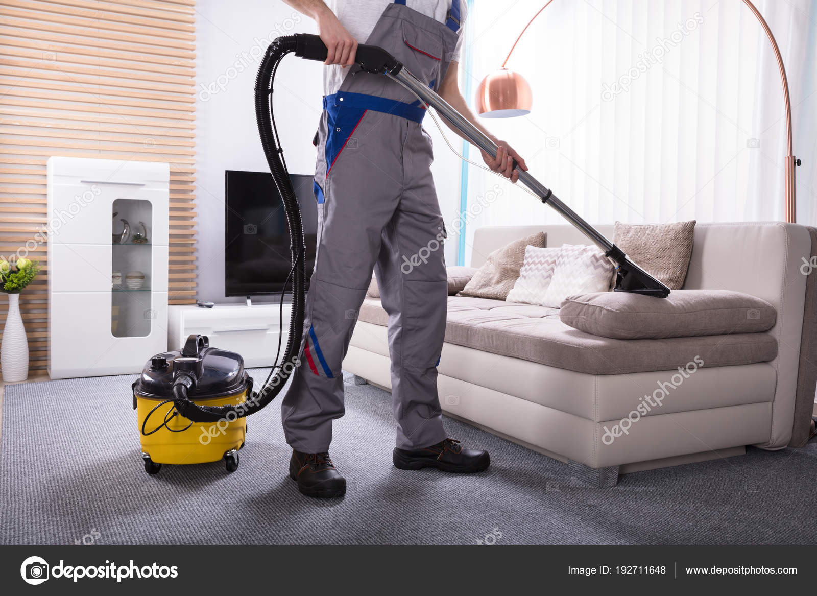 Man Cleaning Sofa Living Room Using Vacuum Cleaner Home Stock Photo By Andreypopov 192711648 Man Cleaning Sofa Living Room Using, How To Clean Sofa At Home With Vacuum Cleaner