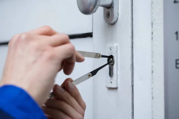 Close-up Of A Person\'s Hand Opening Door With Lockpicker