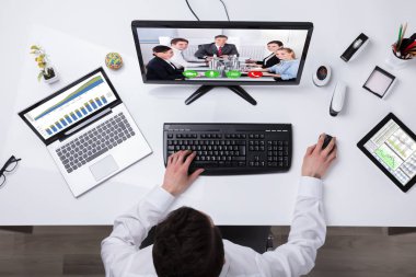 Bir işadamı Video konferans meslektaşları ile yükseltilmiş görünümünü bilgisayardaki