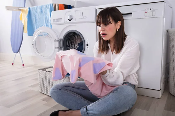 Upset Young Woman Looking Stained Cloth Laundry Room — Stock Photo, Image