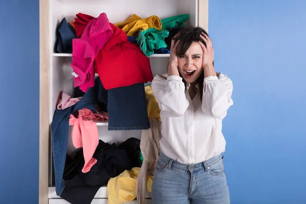 Portrait Stressed Young Woman Front Scattered Clothes Shelf — Stock Photo, Image