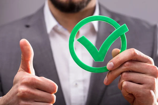 Close Businessperson Hand Holding Green Check Mark Icon — Stock Photo, Image