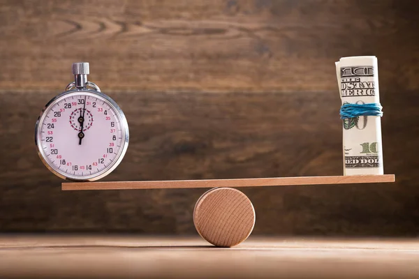 Close Stopwatch Rolled Banknotes Seesaw Wooden Background — Stok Foto