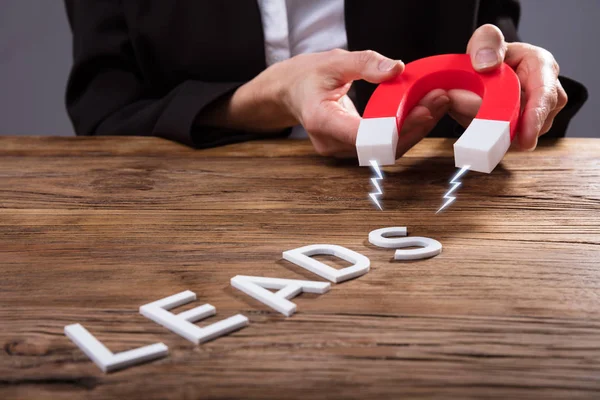 Businessperson Attracting White Lead Text Horseshoe Magnet Wooden Desk — Stock Photo, Image