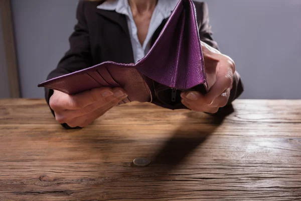 Close Businessperson Hand Holding Empty Purse Wooden Desk — Stock Photo, Image