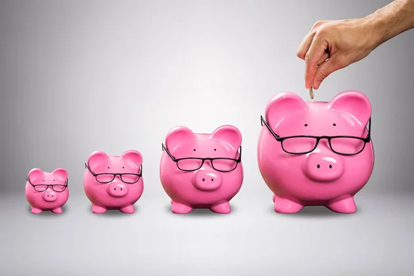 Man Hand Inserting Coin Large Pink Piggybank Eyeglasses Grey Background — Stock Photo, Image