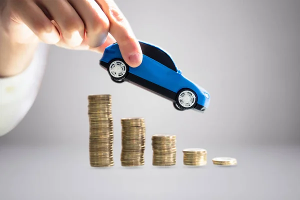 Close Person Hand Holding Blue Model Toy Car Stacked Golden — Stock Photo, Image