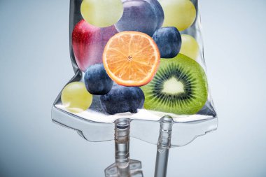 Close-up Of A Different Fruit Slices Inside Saline Bag Hanging With Hook In Hospital clipart