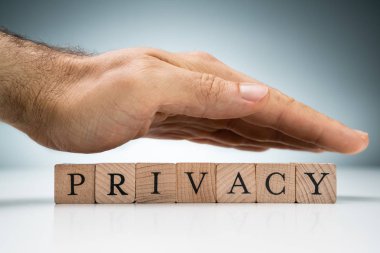 Mahremiyet Ahşap Bloklarını Mavi Arkaplan 'a Karşı Beyaz Masa Üzerinde Adamın Elleri