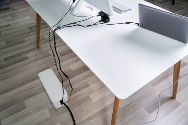 Elevated View Of Compute And Laptop On Desk With Cable Organizer Box Over Hardwood Floor clipart