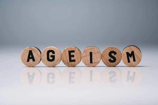 Ageism Text Wooden Blocks Reflective White Desk — Stock Photo, Image