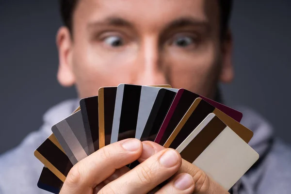 Shocked Man Looking Too Many Credit Cards Holding His Hand — Stock Photo, Image