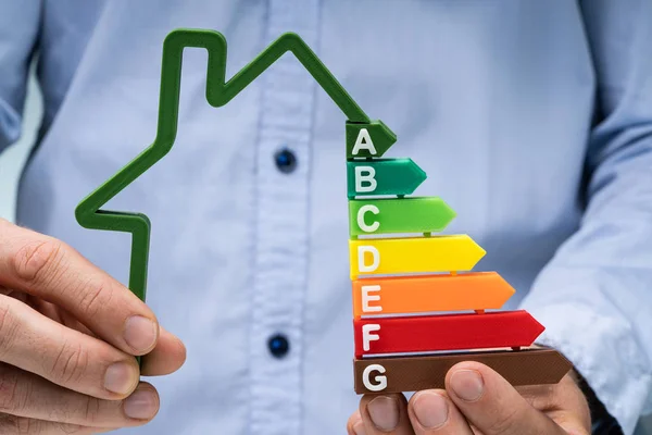 Mid Section Person Hand Holding Green House Energy Efficiency Graph — Stockfoto