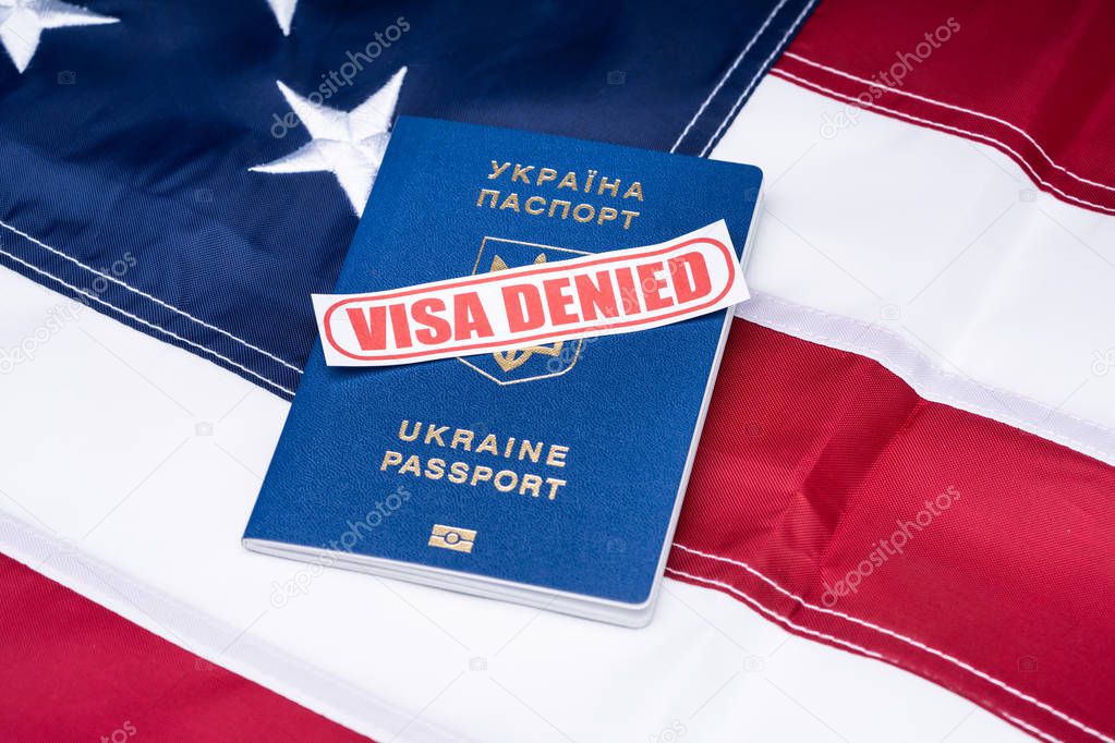 Overhead View Of Visa Denied Text And Ukraine Passport Over American Flag Background