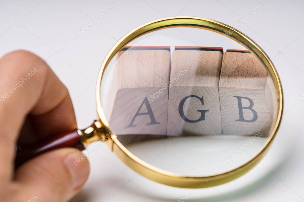 Closeup Of AGB Letters  Under Magnifying Glass. Standard Form Contract In Germany