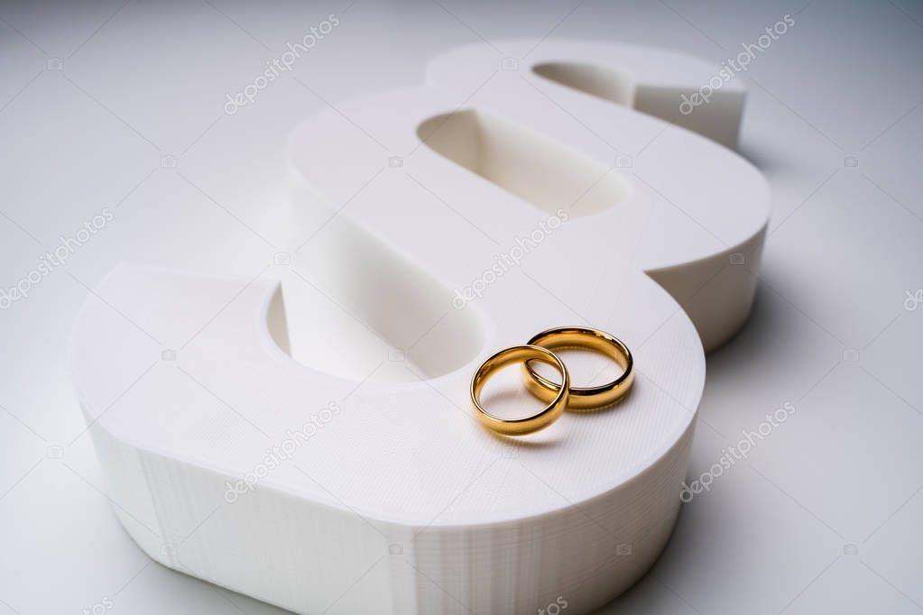 White Paragraph Sign And Golden Wedding Ring Showing Marriage And Law Concept