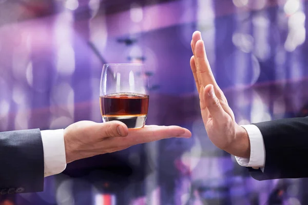 Close Businessman Hand Rejecting Glass Whiskey Offered Businessperson Illuminated Background — Stock Photo, Image