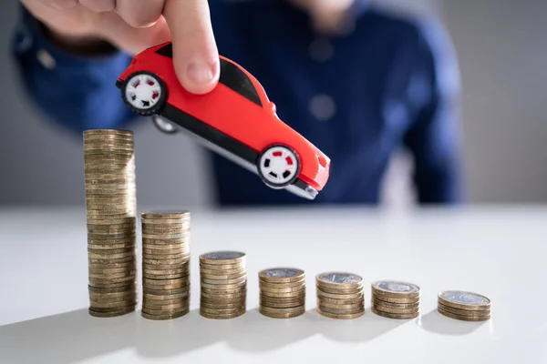 Close Person Hand Flying Car Declining Stacked Coins — Stock Photo, Image