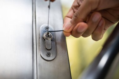 Mature Male Lockpicker Fixing Door Handle At Home clipart