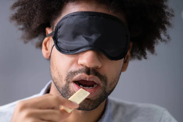 Porträt Eines Jungen Mannes Mit Verbundenen Augen Der Lebensmittel Testet — Stockfoto