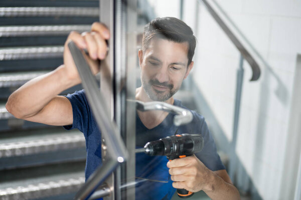 Portrait Young Male Carpenter Repairing Door Lock