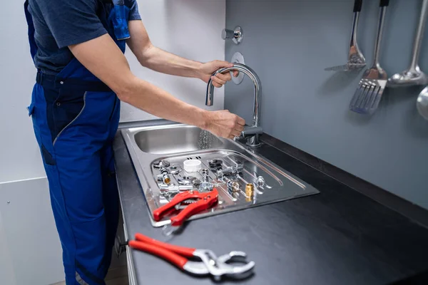 Happy Young Male Plumber Fixing Faucet Kitchen — Stok Foto