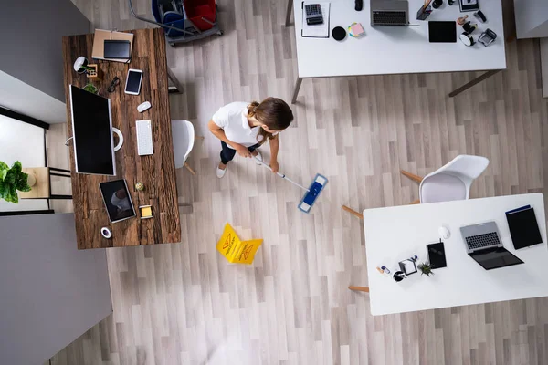 Full Length Female Janitor Mopping Floor Office — Stockfoto