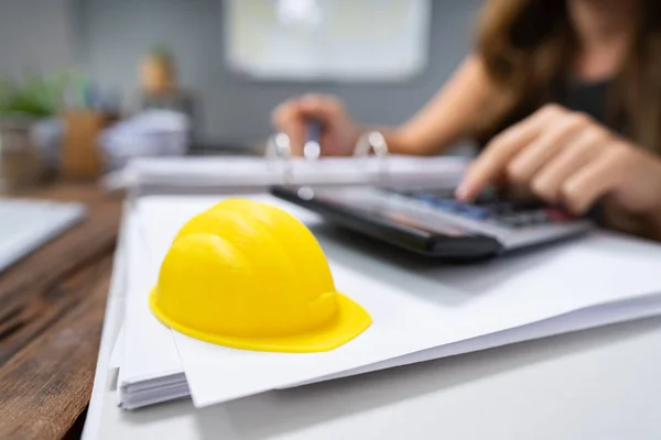 Close Yellow Hard Hat Office Desk Front Woman Calculating Invoice — Stock Photo, Image