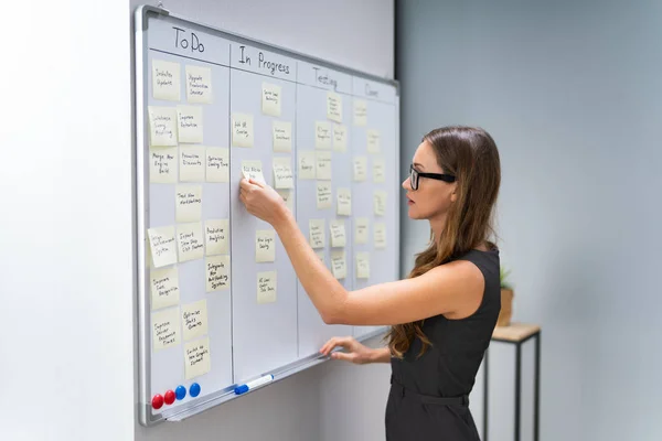 Side View Businesswoman Arranging Sticky Notes Attached White Board Office — Stockfoto