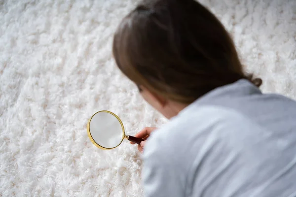 Giovane Femmina Guardando Tappeto Con Lente Ingrandimento — Foto Stock