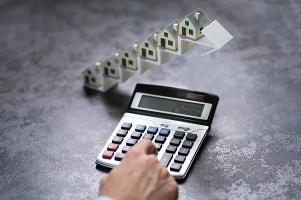 Man Using Calculator Front House Models Increasing Arrow Staircase — Stock Photo, Image