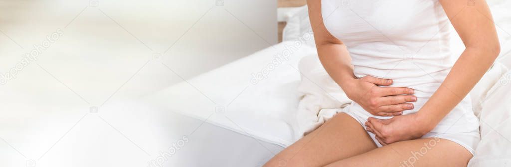 Close-up Of A Woman Suffering From Stomach Pain