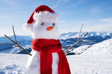 Karlı arazide şapkası ve atkısı olan tamamlanmamış bir kardan adamın düşük açılı görüntüsü