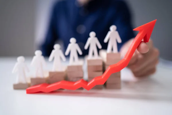 Businessperson Hand Holding Red Arrow Front Human Figures Wooden Staircase — Stock Photo, Image