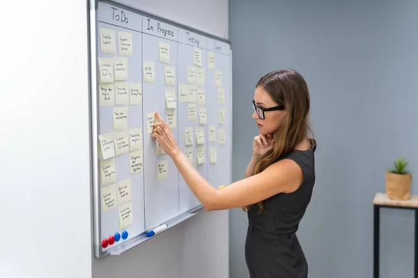 Side View Businesswoman Arranging Sticky Notes Attached White Board Office — Stockfoto