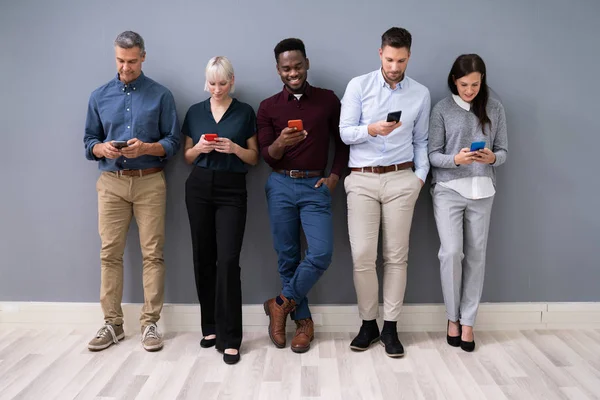 Row Diverse Businesspeople Using Phones Office — Stock Photo, Image