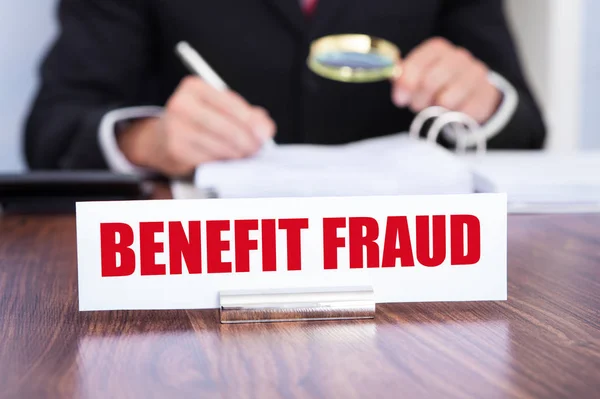 Close Nameplate Benefit Fraud Title Man Checking Documents Using Magnifying — Stock Photo, Image