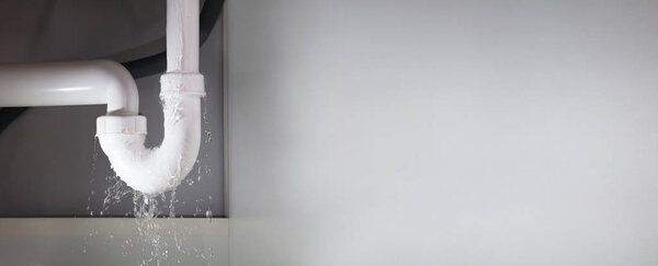 Leakage Of Water From Stainless Steel Pipe On Gray Background