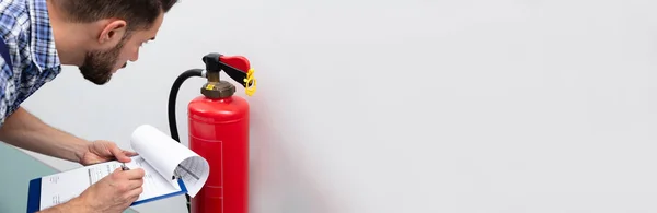 Close Technician Using Digital Tablet Checking Fire Extinguisher — 스톡 사진