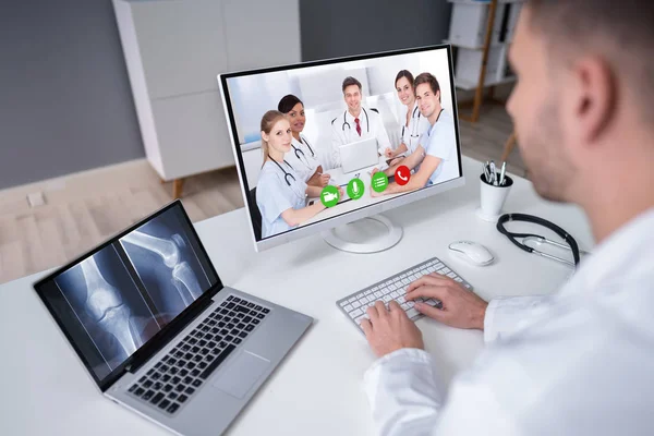 Mature Male Doctor Examining Knee Ray Clinic Video Conference Dalam — Stok Foto