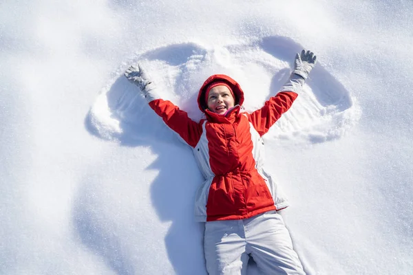 High Angle View Playful Young Woman Lying Snow Enjoying Her — 스톡 사진