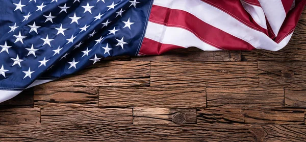 An Overhead View Of American Flag On Wooden Background