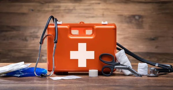 Kit Primeros Auxilios Con Equipo Médico Sobre Fondo Madera —  Fotos de Stock