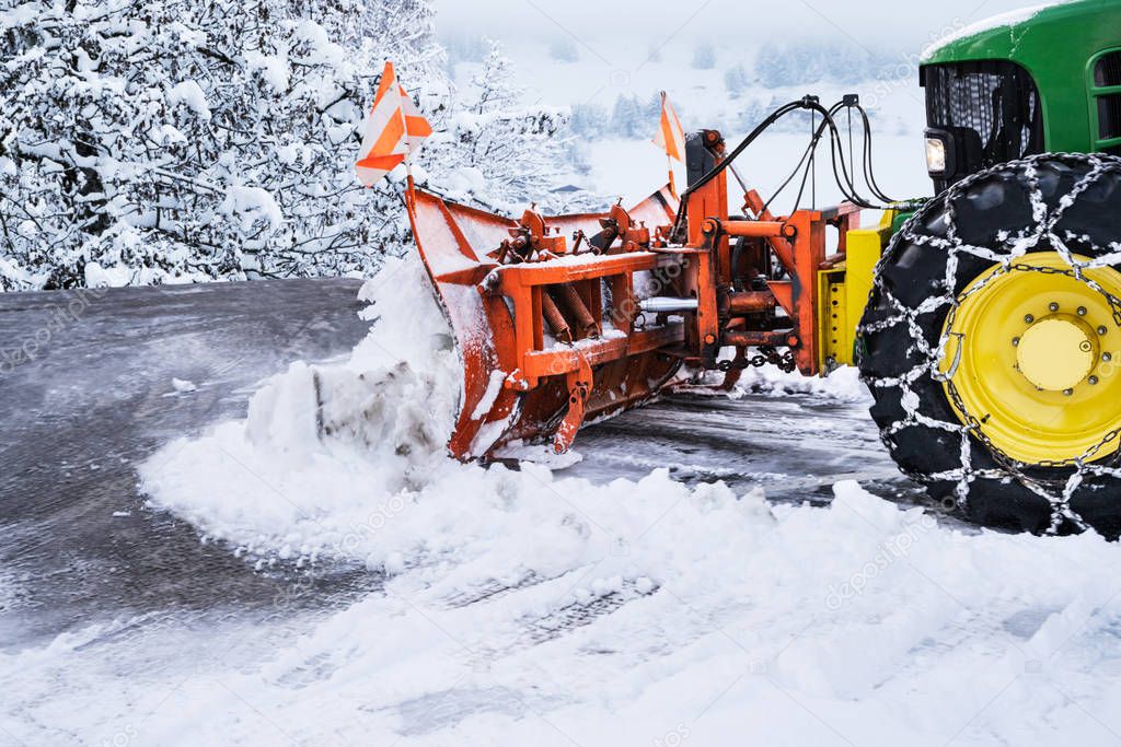 Tractor Cleaning Road From Snow After Heavy Snowfall