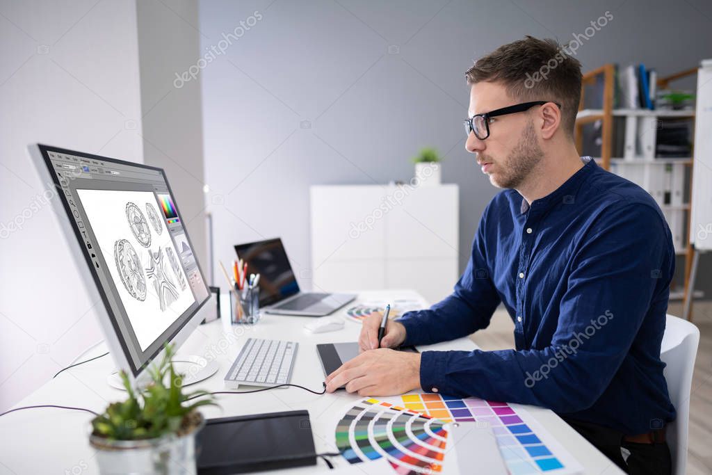 Close-up Of A Designer's Hand Editing Photo On Computer In Office