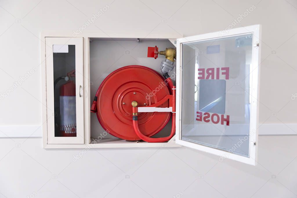 Fire Hose Reel And Fire Extinguisher In Hotel Corridor