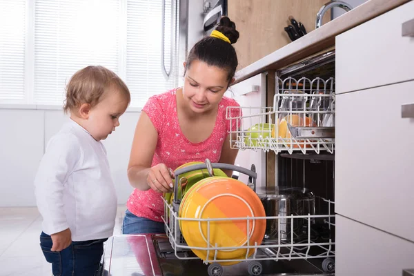 Menina Ajudando Sua Mãe Descarregar Máquina Lavar Louça — Fotografia de Stock