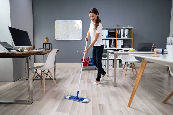 Full Length Female Janitor Mopping Floor Office — Stockfoto