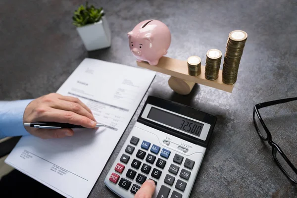 Man Calculating Bill Pink Piggybank Increasing Stacked Coins Balancing Seesaw — Stock Photo, Image