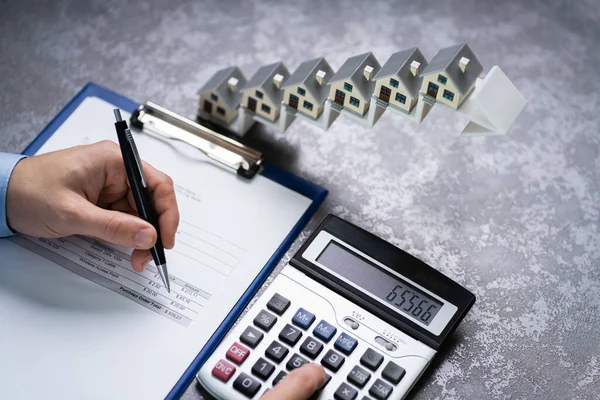 Man Calculating Invoice Front House Models Increasing Arrow Staircase — Stock Photo, Image